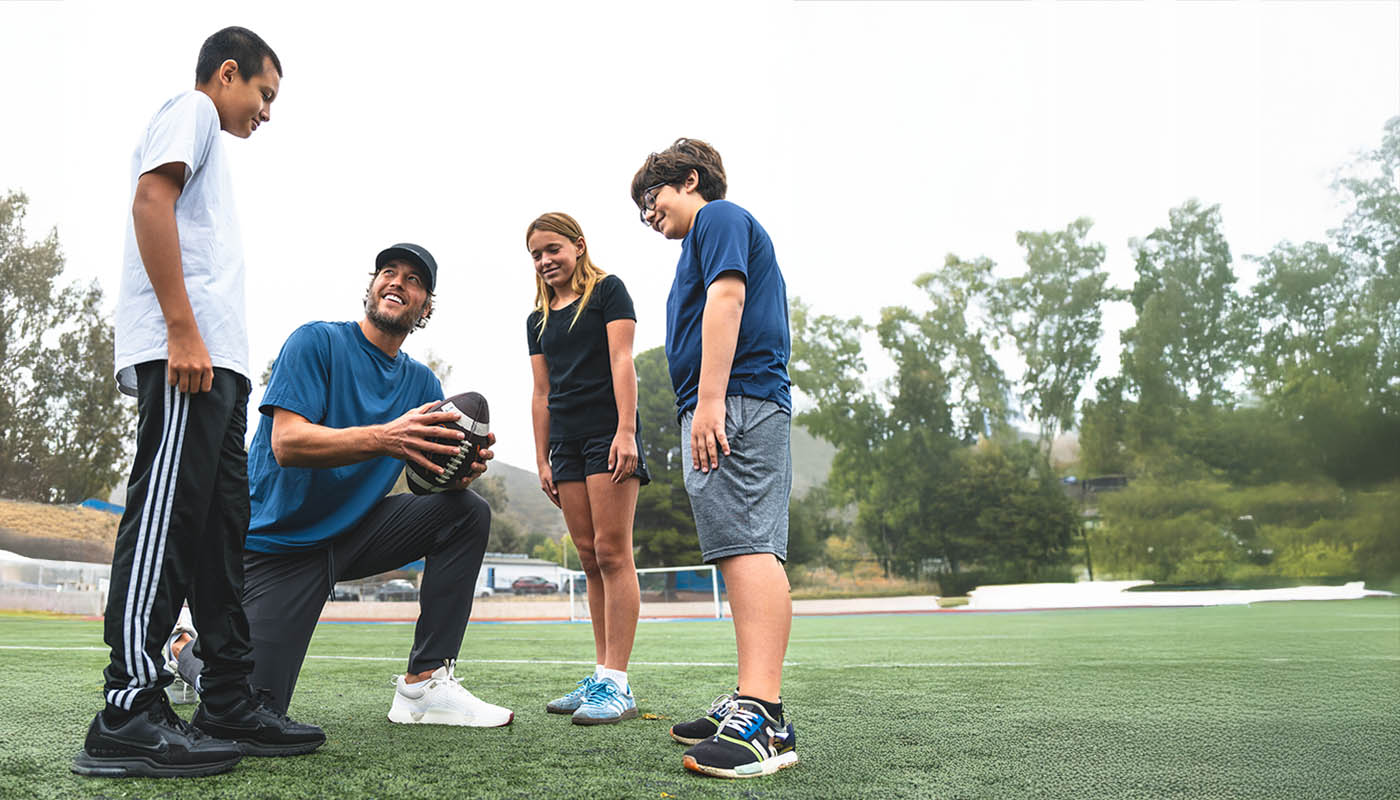 Matthew Stafford playing football with kids