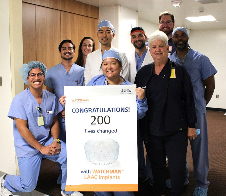 The electrophysiology team at MemorialCare Heart & Vascular Institute at Long Beach Medical Center holding a sign celebrating their landmark 200th WATCHMAN procedure.