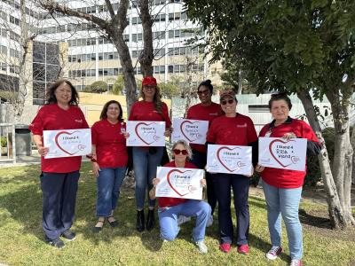 Care team members from the Trauma Center at MemorialCare Long Beach Medical Center and Miller Children’s & Women’s Hospital display the postcards honoring the women they stand for on National Wear Red Day.