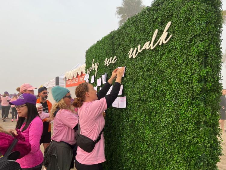 Members who joined the walk adding small pieces of paper to a bush explaining why they walked during the Team Spirit walk. 