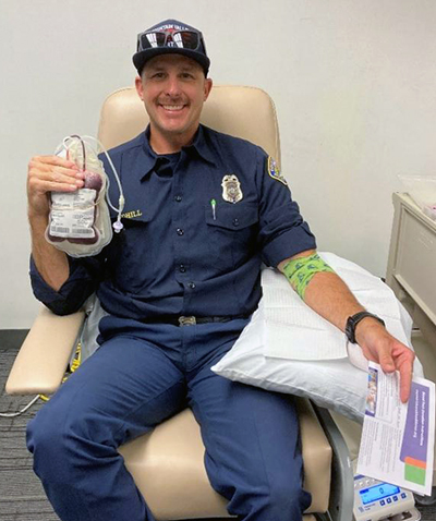 A Fountain Valley fireman holding the bag of blood he donated to MemorialCare Orange Coast Medical Center. 
