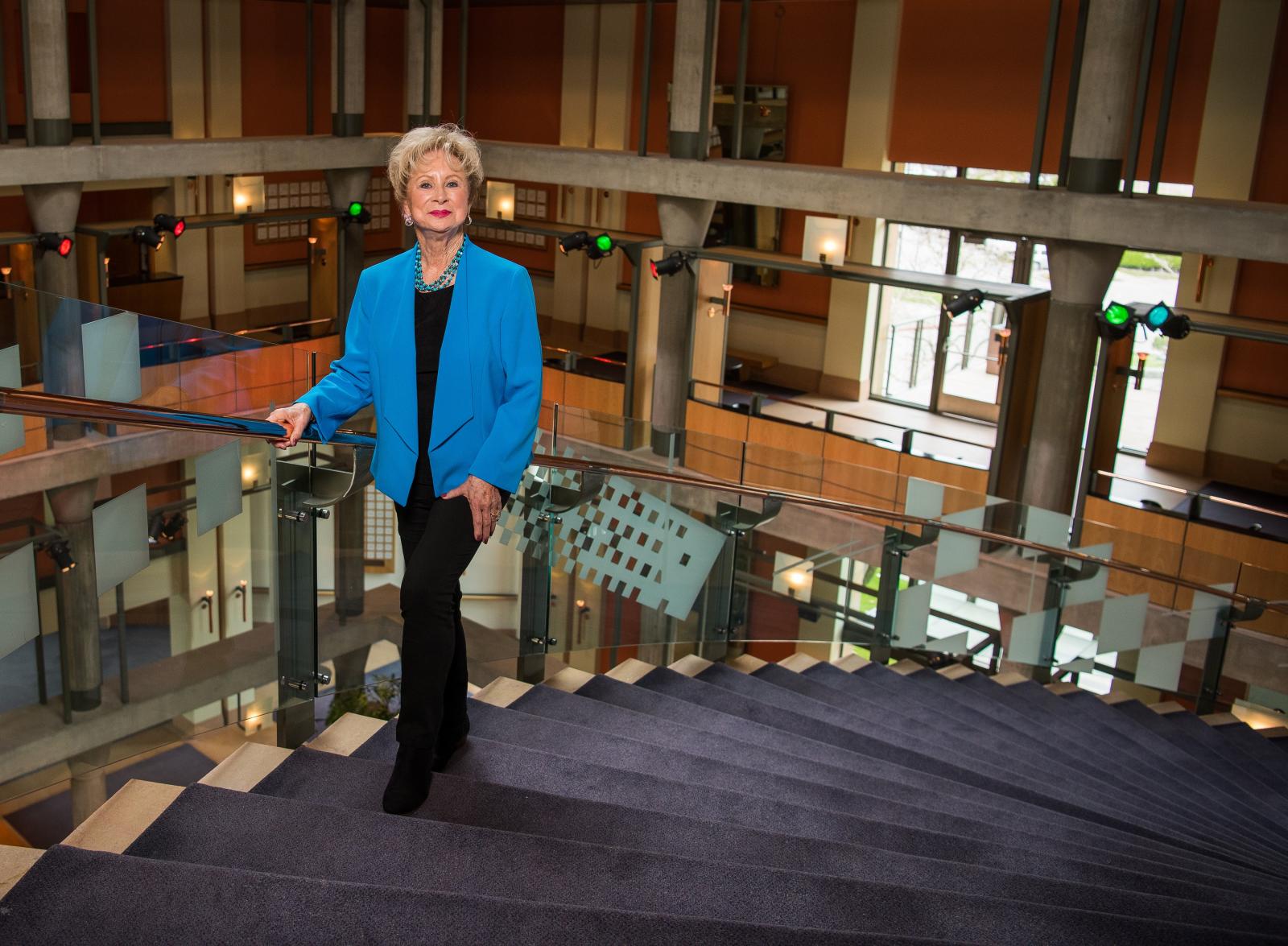 Image of Brenda, standing on a staircase, who is a MemorialCare Long Beach Medical Center spine surgery patient